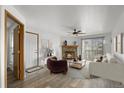 Living room with fireplace, hardwood floors, and staged furniture at 7820 W 87Th Dr # K, Arvada, CO 80005