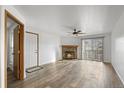 Bright living room featuring hardwood floors and a stone fireplace at 7820 W 87Th Dr # K, Arvada, CO 80005