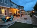 Inviting backyard featuring a patio with string lights, outdoor furniture, and a fire pit, perfect for entertaining at 3902 Eagle Tail Ln, Castle Rock, CO 80104