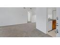 Bright living room featuring neutral carpet and white walls at 10715 Twenty Mile Rd # 203, Parker, CO 80134