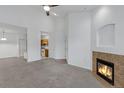 Open living area with fireplace and a view into the kitchen at 10715 Twenty Mile Rd # 203, Parker, CO 80134