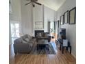 Bright living room with vaulted ceilings, a fireplace, and hardwood floors at 5425 W 115Th Pl, Westminster, CO 80020
