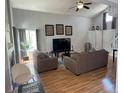Cozy living room with vaulted ceilings, fireplace, and new flooring at 5425 W 115Th Pl, Westminster, CO 80020