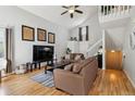 Open-concept living room with vaulted ceiling, light-colored walls, and hardwood flooring at 5425 W 115Th Pl, Westminster, CO 80020