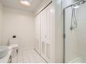 Bathroom featuring tile floors, sleek white cabinets and a glass-enclosed shower at 300 W 11Th Ave # 4F, Denver, CO 80204