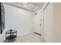 Inviting foyer featuring tile flooring, modern lighting, and a convenient coat closet for ample storage at 300 W 11Th Ave # 4F, Denver, CO 80204