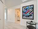 Hallway with modern decor and stylish art, leading to a bright bathroom at 300 W 11Th Ave # 4F, Denver, CO 80204