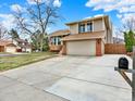 Beautiful two-story home with a spacious driveway and a well-maintained lawn at 3973 S Joplin Way, Aurora, CO 80013