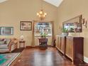 Living room featuring hardwood floors, an ornate buffet cabinet, and bright window for natural light at 3973 S Joplin Way, Aurora, CO 80013