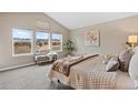 Bright main bedroom with vaulted ceilings, large windows, and a serene view at 14284 W 88Th Dr # B, Arvada, CO 80005