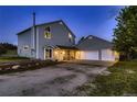 Beautiful two-story house with an attached two-car garage and cozy front porch seating area, set for comfort at 8370 Midsummer Ln, Elizabeth, CO 80107
