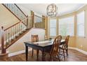 Dining area with hardwood floors and modern chandelier near staircase at 42350 Forest Oaks Dr, Elizabeth, CO 80107