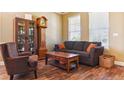 Cozy living room with comfortable seating, hardwood floors and decorative cabinet at 42350 Forest Oaks Dr, Elizabeth, CO 80107