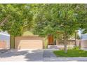 A charming home featuring a large driveway, front porch, and lush green lawn at 676 Hedgerow Way, Brighton, CO 80601