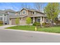 Beautiful two-story home with manicured lawn, decorative fence, and inviting curb appeal at 17297 Opal Hill Dr, Parker, CO 80134