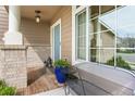 Inviting front porch featuring stylish bench seating, brick pillars, and covered entry at 17297 Opal Hill Dr, Parker, CO 80134