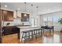 Gourmet kitchen features granite countertops, stainless steel appliances, and a large island with seating at 2562 S Kendrick St, Denver, CO 80228