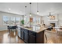Open kitchen and living area featuring a large island with granite countertops and stainless steel appliances at 2562 S Kendrick St, Denver, CO 80228