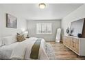 Bright main bedroom with a large window, wood floors, modern decor, and a serene atmosphere at 2562 S Kendrick St, Denver, CO 80228