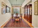 Formal dining room showcasing hardwood floors, classic chandelier, and refined china cabinet at 2571 Hunters Pl, Highlands Ranch, CO 80129