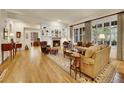Comfortable living room with hardwood floors, fireplace, and large windows for ample natural light at 2571 Hunters Pl, Highlands Ranch, CO 80129