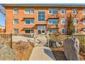 Brick apartment building featuring symmetrical design, large windows, and a welcoming entrance with stone accents at 1201 Balsam Ave # 203, Boulder, CO 80304