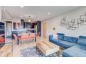 Stylish living room featuring hardwood floors, a comfortable blue sofa, and an open-concept layout with a dining area at 1201 Balsam Ave # 203, Boulder, CO 80304