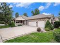 Beautiful home exterior with a charming porch and a spacious three-car attached garage at 1405 Castlepoint Circle, Castle Pines, CO 80108