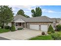 Inviting home exterior features a cozy front porch and a convenient three-car garage at 1405 Castlepoint Circle, Castle Pines, CO 80108
