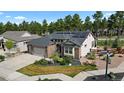 Charming single-story home featuring a three-car garage, solar panels and lush front yard at 1734 Summerglow Ln, Monument, CO 80132