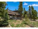 Charming home featuring a large deck, and a well-maintained yard surrounded by mature trees at 24 Ski Pole Ct, Breckenridge, CO 80424