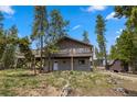 Charming home with a spacious deck, storage shed, and well-maintained yard surrounded by mature trees at 24 Ski Pole Ct, Breckenridge, CO 80424