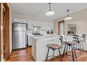 Bright kitchen features white cabinets, stainless steel appliances, and a sleek island with barstool seating at 24 Ski Pole Ct, Breckenridge, CO 80424