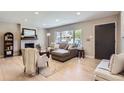 Inviting living room with large window, fireplace, neutral color palette, and hardwood floors at 3576 S Holly St, Denver, CO 80237