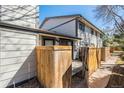 View of the exterior of the house showing a fenced in yard with wood slats for privacy at 15157 E Louisiana Dr # A, Aurora, CO 80012