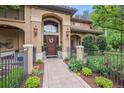 Charming home entrance featuring a decorative door, stone walkway and manicured landscaping at 5335 E 2Nd Ave, Denver, CO 80220