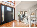 Elegant foyer with hardwood floors, high ceilings, a decorative staircase, and ample natural light at 4534 Palmer Ct, Longmont, CO 80503