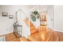 Lovely home staircase featuring hardwood steps and white railings, complemented by stylish decor at 4534 Palmer Ct, Longmont, CO 80503