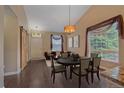Elegant dining room featuring a chandelier, hardwood floors, and large windows at 9406 Troon Village Way, Lone Tree, CO 80124