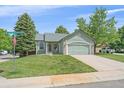 Attractive single-story home with a well-kept lawn and a two-car garage at 9406 Troon Village Way, Lone Tree, CO 80124