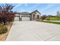Spacious home with a three-car garage, a well-manicured lawn, and beautiful landscaping at 21376 E Union Pl, Aurora, CO 80015