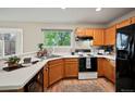 Spacious kitchen featuring wood cabinets, white countertops, and black appliances at 19229 E Legend Ave, Parker, CO 80134