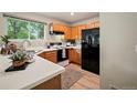 Bright kitchen with wood cabinets, white countertops, and black appliances at 19229 E Legend Ave, Parker, CO 80134