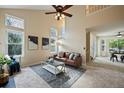 Open living room with vaulted ceiling, fireplace, and neutral decor at 19229 E Legend Ave, Parker, CO 80134