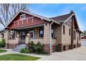 Low angle exterior view of brick home with front porch and basement windows at 1418 Perry St, Denver, CO 80204