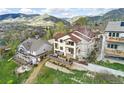 Aerial view of a beautiful home with mountain views and a large deck, perfect for outdoor entertaining at 415 Butte Pkwy, Golden, CO 80403