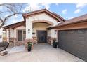 Inviting front entrance with stone accents, a decorative front door, and manicured landscaping at 415 Butte Pkwy, Golden, CO 80403
