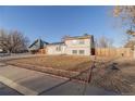 Exterior view of a two-story home with solar panels and a well-maintained yard with decorative rock border at 3531 E 122Nd Ave, Thornton, CO 80241