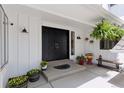 Inviting front porch with double doors, decorative plants, and cozy seating at 6075 S Filbert Ct, Centennial, CO 80121