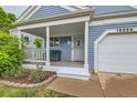 Inviting front porch with a white railing and a comfortable seating area, perfect for relaxing outdoors at 12060 N Holly Way, Brighton, CO 80602